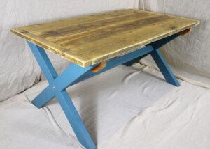Farmhouse dining table made from reclaimed wood, with blue painted legs
